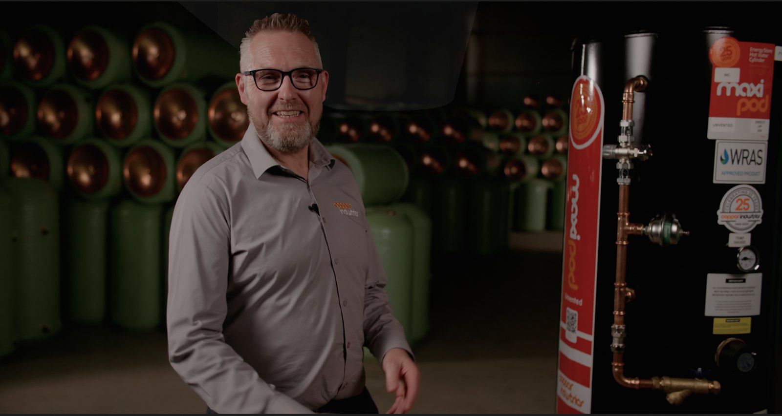 Copper Industries presenter beside a cylinder in the factory